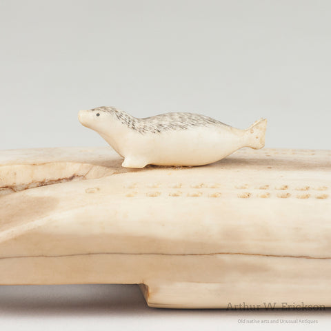 Inuit Carved Fossilized Ivory Cribbage Board with Scrimshawed Ivory Seals
