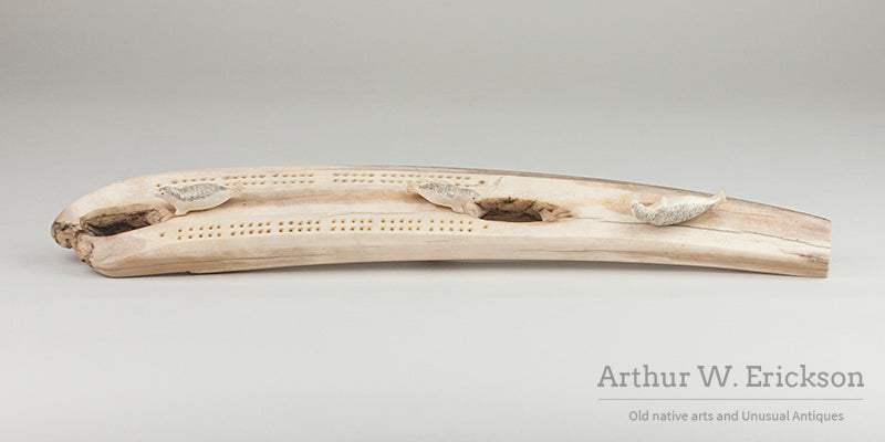 Inuit Carved Fossilized Ivory Cribbage Board with Scrimshawed Ivory Seals