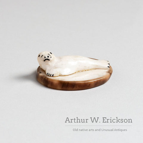Small Walrus Ivory Resting Seal on a Mount of Fossilized Walrus Ivory