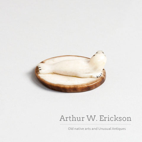 Small Walrus Ivory Resting Seal on a Mount of Fossilized Walrus Ivory