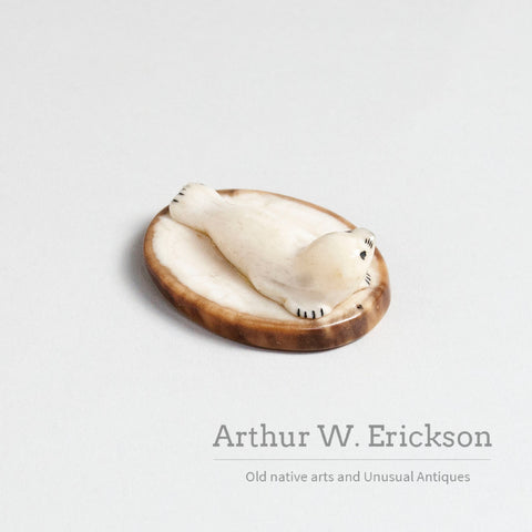 Small Walrus Ivory Resting Seal on a Mount of Fossilized Walrus Ivory